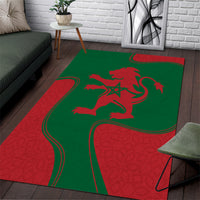 Green and red area rug with red lion emblem and star graphic in center