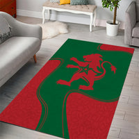 Green and red area rug featuring red lion emblem and sweeping ribbon design