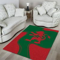 Green and red rectangular area rug with red lion emblem and ornate border