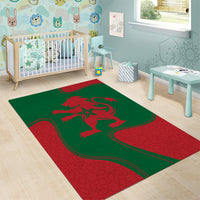 Green and red kids area rug with red lion emblem and rounded border outline