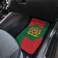 Red and green car mat with gold crest and wavy Moroccan flag stripe border