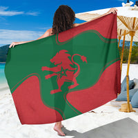 Green and red sarong with Morocco lion emblem, held horizontally for display