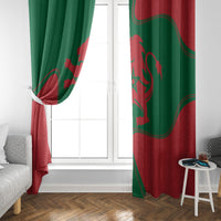 Red and green Morocco flag window curtain panels, tied open at the side.