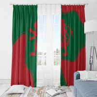 Green and red Morocco flag curtains with grommet holes, framed behind sheer light.