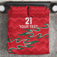 Red bedding set with two matching pillows and green graphic, "21" and "YOUR TEXT"