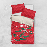 Red bedding set with two red pillows and a comforter panel featuring green graphic and "YOUR TEXT"