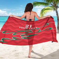 Red sarong draped at back, green flame pattern with “21” and “YOUR TEXT”