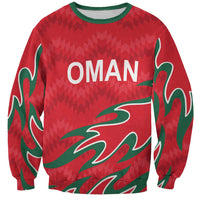 Red sweatshirt with green trim, OMAN graphic, long sleeves