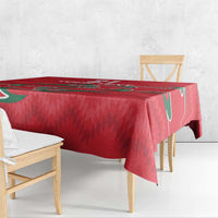 Red tablecloth over bench seating; green accents and geometric pattern visible.