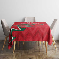 Red tablecloth on small table with green stripe accents and partial “YOUR TEXT”.