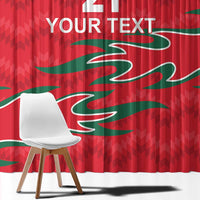 Red custom curtain with green wave pattern and “YOUR TEXT” at top, close-up detail.