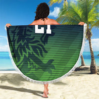Round green beach blanket with fringe edge, camo pattern and number 21, held up outdoors