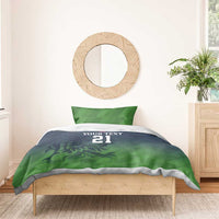 Green and navy duvet cover with 'YOUR TEXT 21' and matching pillowcases on a bed