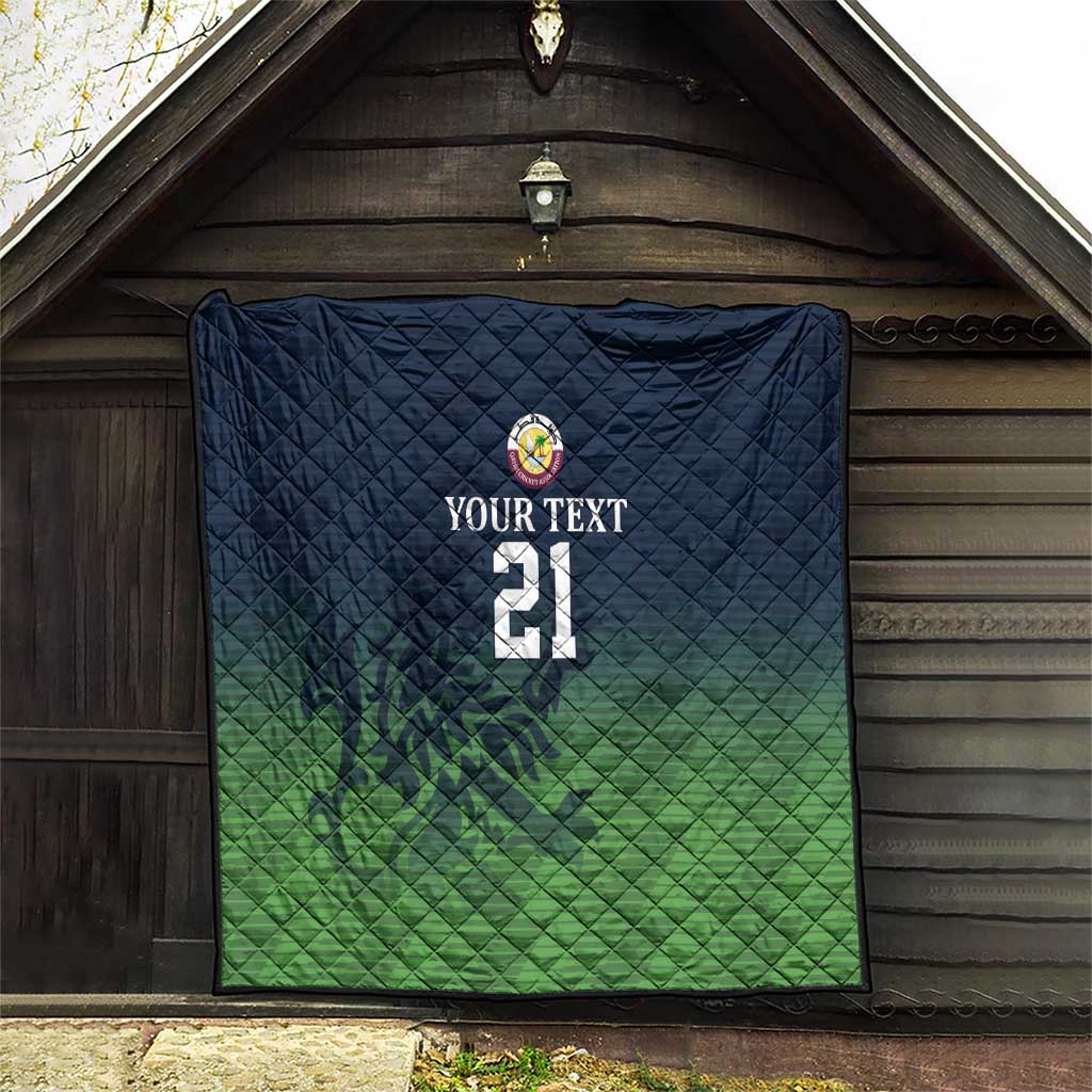 Green and dark blue quilt hanging on wall with crest logo, custom text, and number 21
