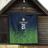 Green and dark blue quilt hanging on wall with crest logo, custom text, and number 21