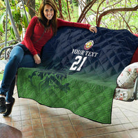 Green and dark blue quilt with custom text, crest logo, and number 21 draped