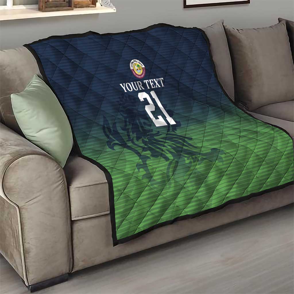 Green and dark blue quilt on couch with custom text, crest logo, and number 21