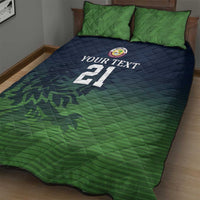 Green and navy quilt with two pillows, 'YOUR TEXT' and number 21, cricket pattern