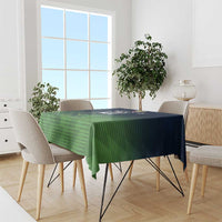 Green patterned tablecloth covering dining table, with matching overhang on sides