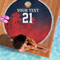 Round beach blanket, red lion and "21" on navy background, with white tassel fringe