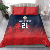 Red and dark blue bedding set with two red pillow shams, lion emblem and number 21