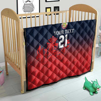 Cricket quilt in baby crib with navy quilted diamonds, red bottom, crest and number 21