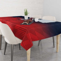 Red sports tablecloth with striped pattern and corner drape over square dining table.