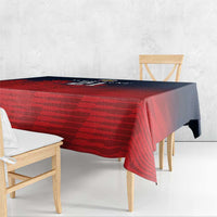 Red sports tablecloth with striped pattern, long side drape over wood dining benches.