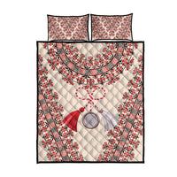 Quilt bed set featuring cream quilt with red black patterned embroidery and two square pillows