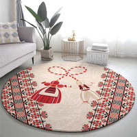 Beige round carpet with red-and-white martenitsa hearts and border stripes on floor