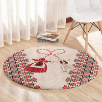 Beige round carpet with red martenitsa bow motif and geometric side border