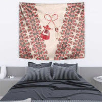 Beige tapestry with red patterned borders and hanging doll figures