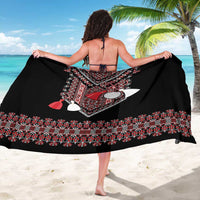 Black sarong with central Romanian-style folk motif and red tassel accents