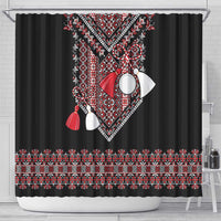 Black shower curtain with central red geometric folk pattern, white accents, and tassel details