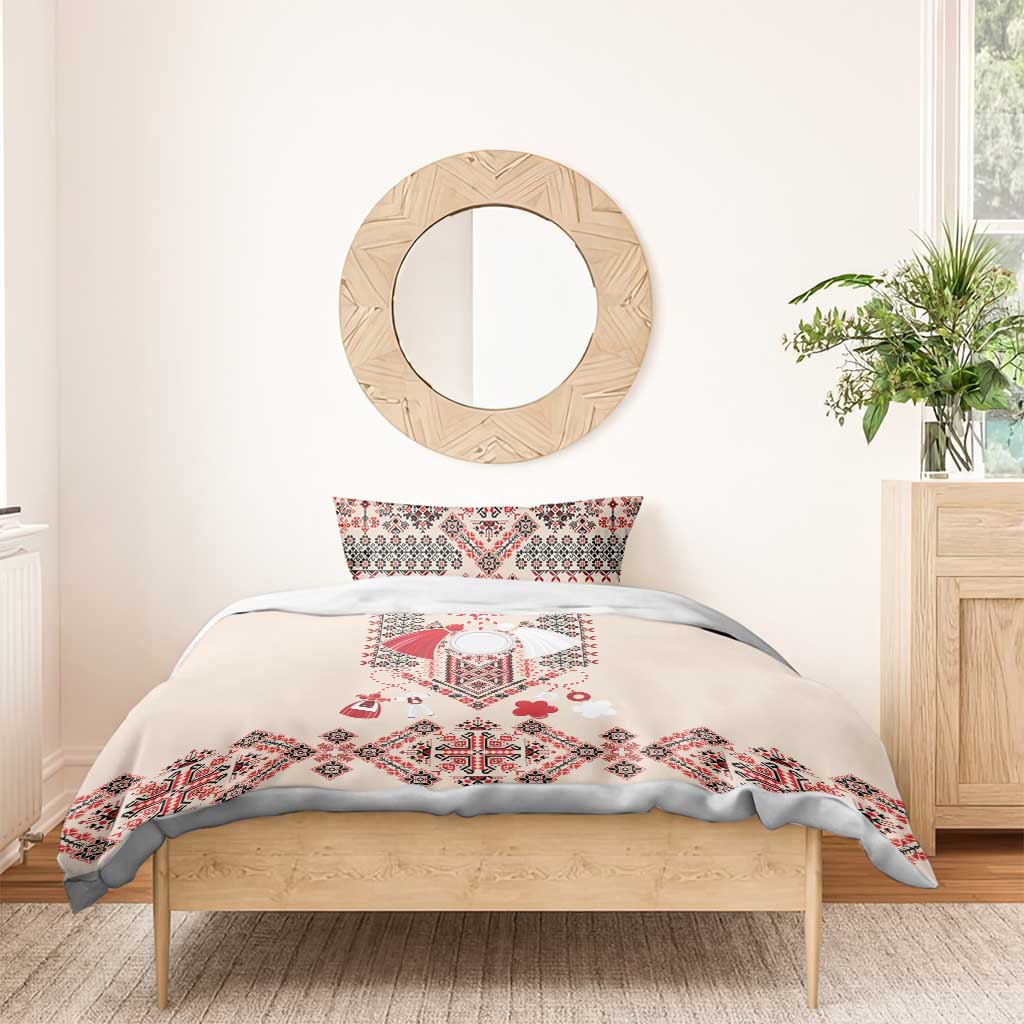 Beige duvet cover with red folk embroidery center panel and geometric accents; two pillowcases