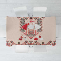 Beige tablecloth with red and navy folk embroidery diamond pattern and scalloped border