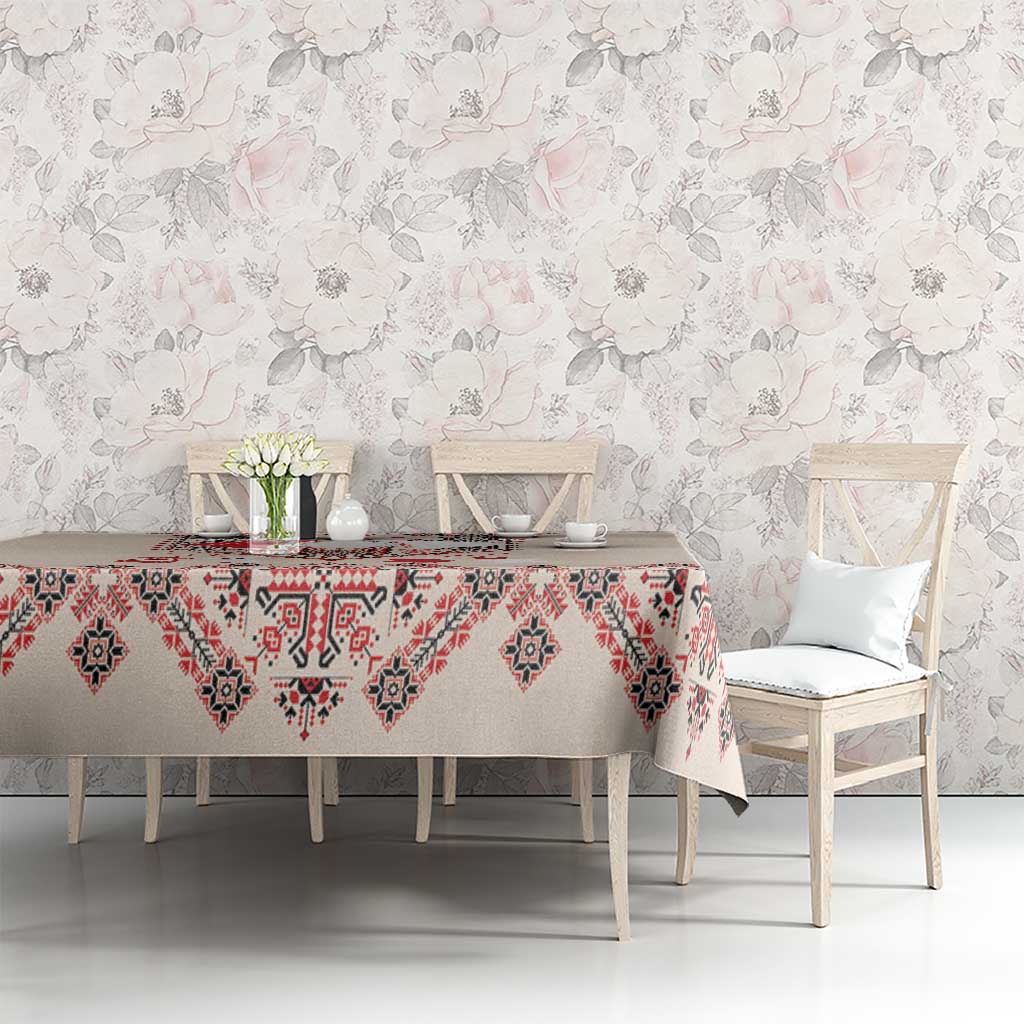 Beige tablecloth with red and navy folk embroidery pattern on buffet table setting