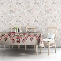 Beige tablecloth with red and navy folk embroidery pattern on buffet table setting