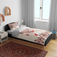 Beige duvet and pillows with red-and-blue traditional embroidery in a bedroom setting