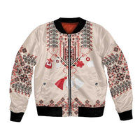 Beige bomber jacket with front zipper and colorful folk embroidery, black ribbed cuffs.