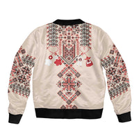 Beige bomber jacket back with colorful folk embroidery and black ribbed hem, full sleeves.