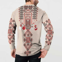 Beige button-placket sweatshirt, back view, long sleeves, red/white folk embroidery, on model
