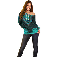 Women’s teal off-shoulder sweater featuring large turquoise medallion pattern, long sleeves