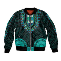 Teal and black dashiki-style zip bomber jacket with turquoise Polynesian pattern, ribbed cuffs.