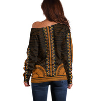 Back view off-shoulder sweater on dark base with gold geometric motif, long sleeves