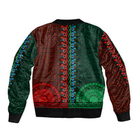 Dashiki bomber jacket back, half green/half red tapa patterns, black ribbed hem and cuffs