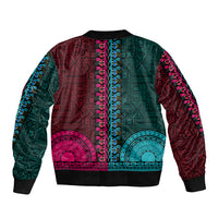 Multicolor bomber jacket, teal and pink tapa pattern, black ribbed collar and hem, back view