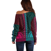 Back of off-shoulder dashiki-style sweater with teal, pink, and blue geometric tapa panel