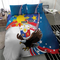 Close view of blue bedding set featuring eagle and sun design with “YOUR TEXT” text