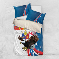 Overhead view of blue bedding set with eagle and sun artwork, two pillows matching
